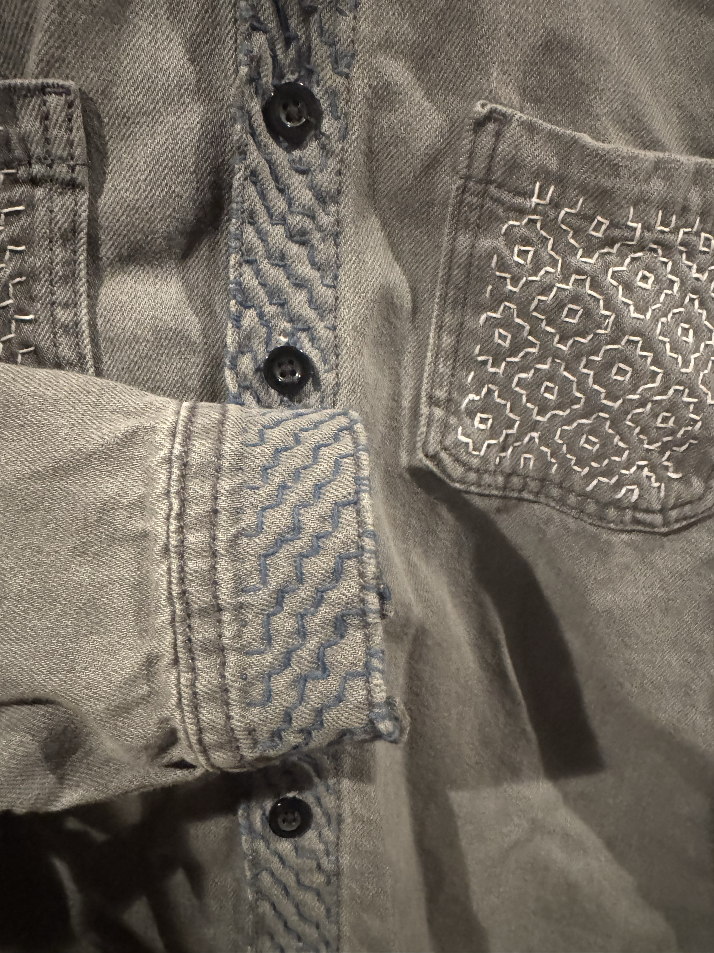 A button-up shirt restored with artful mending